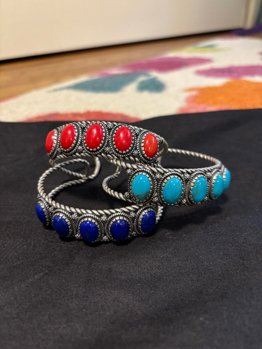 Sterling silver bracelets set with turquoise, coral and lapis.